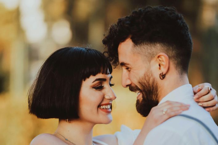A happy couple shares a loving moment outdoors in İzmir, Türkiye.
